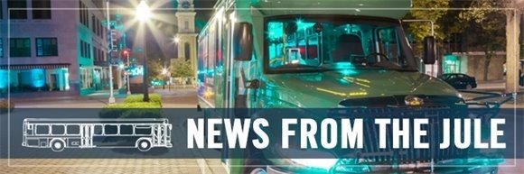 News from The Jule. The Jule MiniBus in the foreground, downtown City of Dubuque in the background.