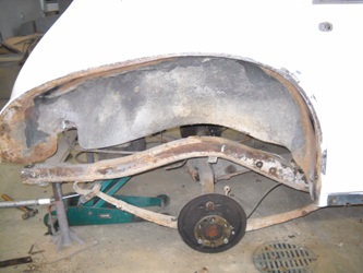 Rust around a wheel well.