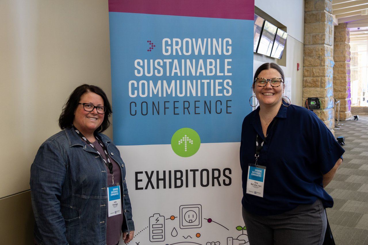 Conference Hosts Julie Kronlage and Gina Bell stand with a GSC Sign